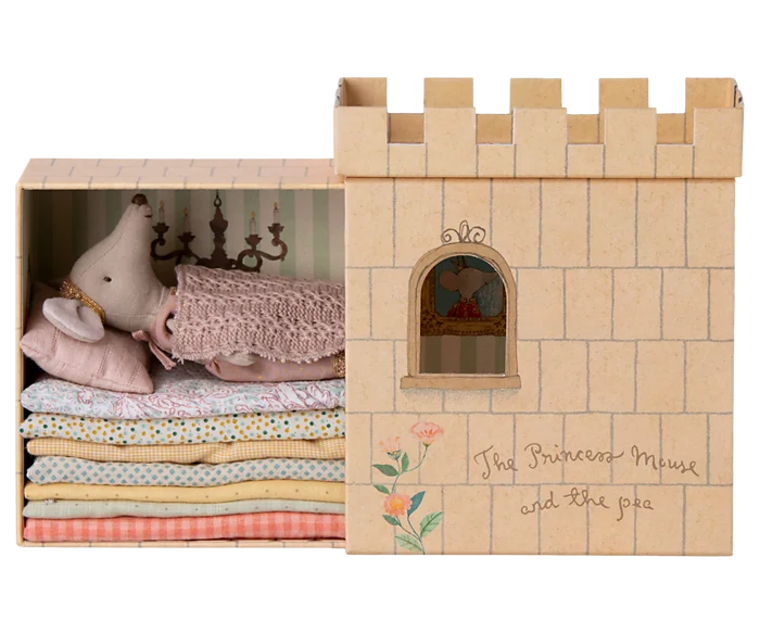 Maileg Princess and the Pea Big Sister Mouse — princess mouse doll resting atop a stack of colorful fabric mattresses inside the illustrated castle playset box, labeled 'The Princess Mouse and the Pea'