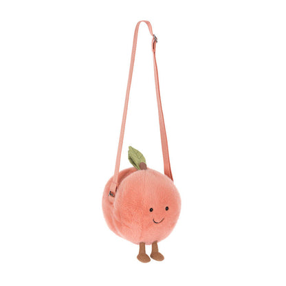 Plush peach-shaped bag with a strap on a white background