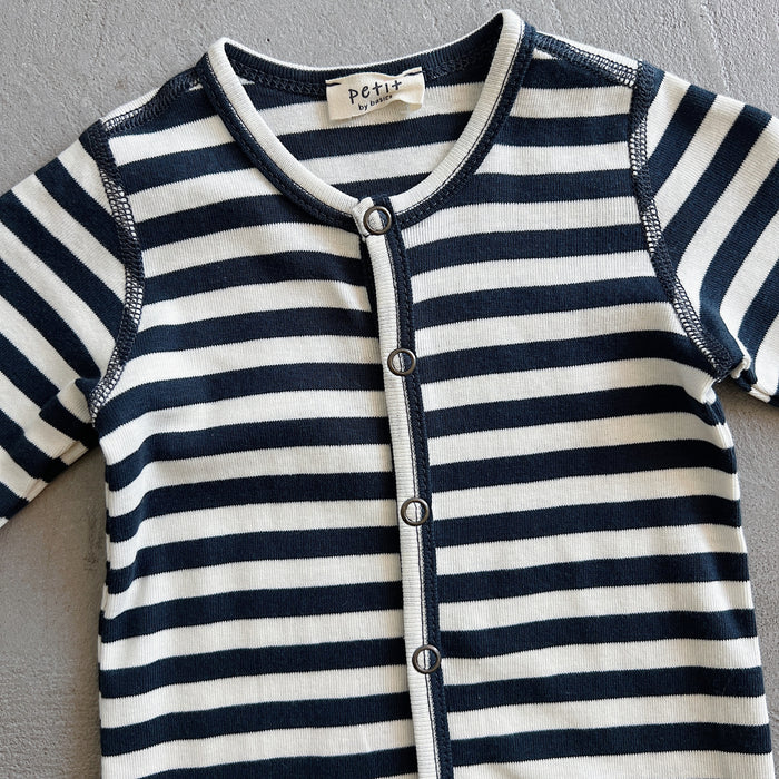 Navy and white striped baby outfit with 'petit' label on a gray background