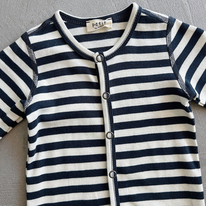 Navy and white striped baby outfit with 'petit' label on a gray background