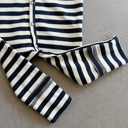 Navy and white striped outfit on a gray surface