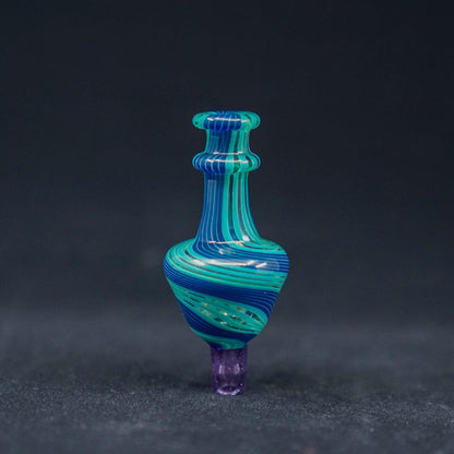 JWalkerGlass Linework Bubble Carb Cap - Artistic and Precise: Hand-blown by @JWalkerGlass, Intricate Linework, Color Accents, Compatible with 25mm and 30mm Bangers, Precise Airflow Control, Made from High-Quality Borosilicate Glass, Heat Resistance and Durability, Choose from Vibrant Color Combinations, Blue/Teal/Pink or Red/Gray/Yellow, Personalize Your Setup.