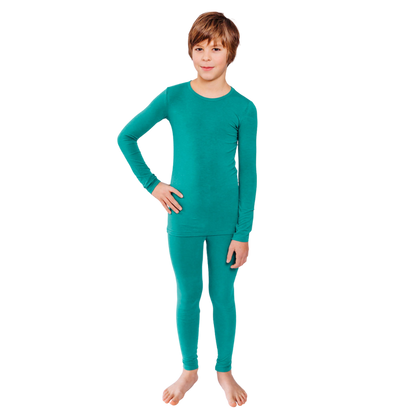 Boy with hand on hip wearing teal Remeywear long sleeve shirt and long pants.