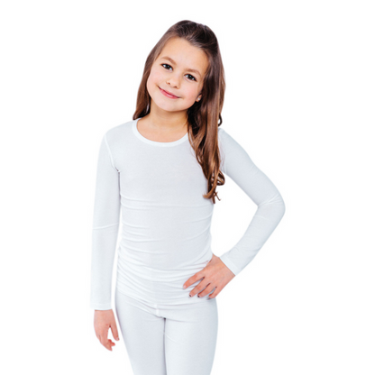 Girl with hand on hip wearing a white Remdywear long sleeve shirt for eczema.