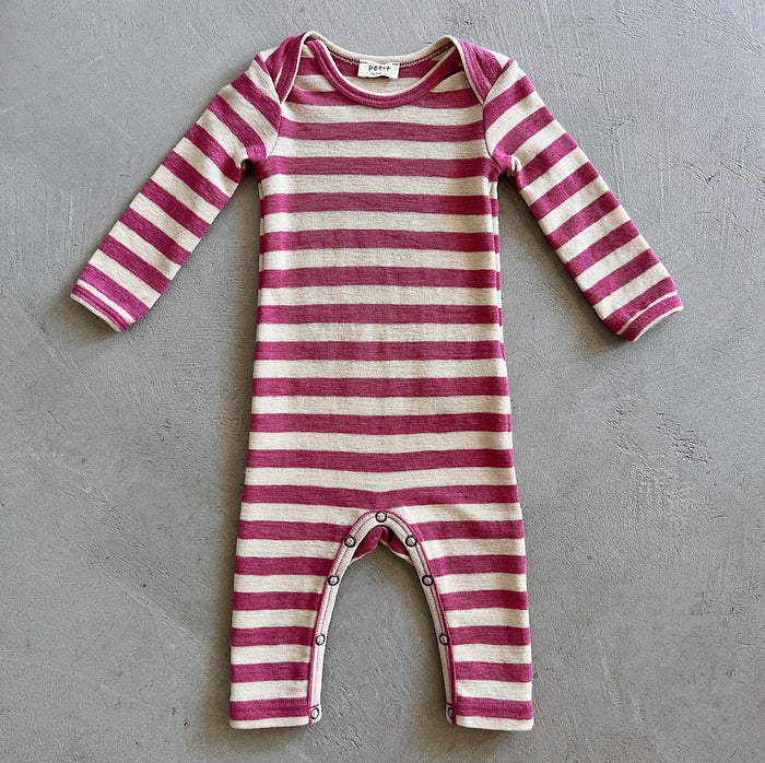 Striped baby onesie on a gray surface