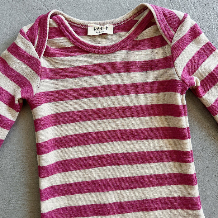 Striped baby onesie with pink and white stripes on a gray background