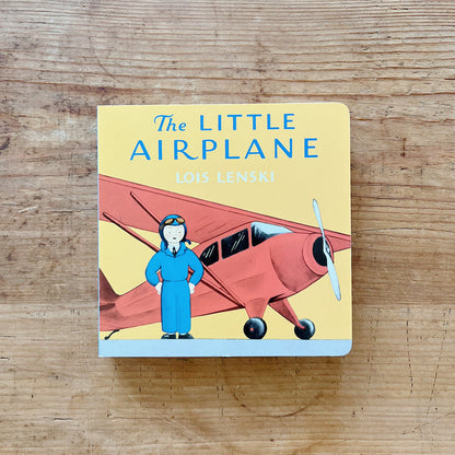 Cover of The Little Airplane by Lois Lenski, a yellow square board book featuring Pilot Small in a blue flight suit and goggles standing in front of a large red propeller airplane